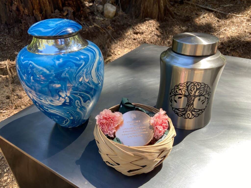 memorial marker with urns and flowers