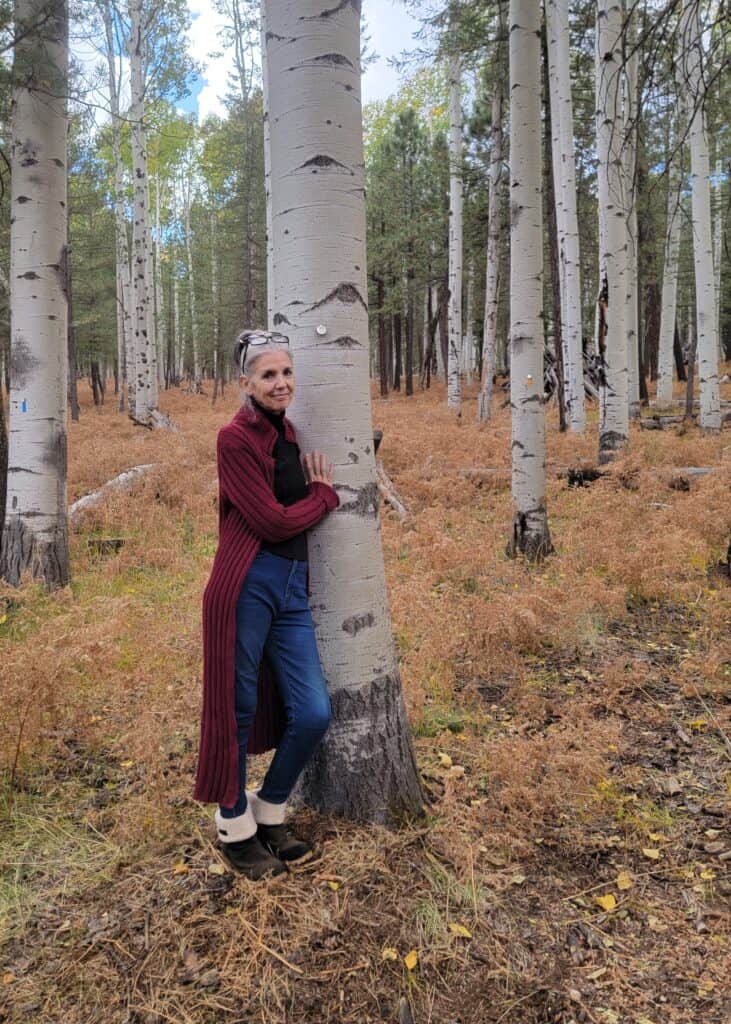 A woman hugs her memorial tree during her husbands memorial in flagstaff
