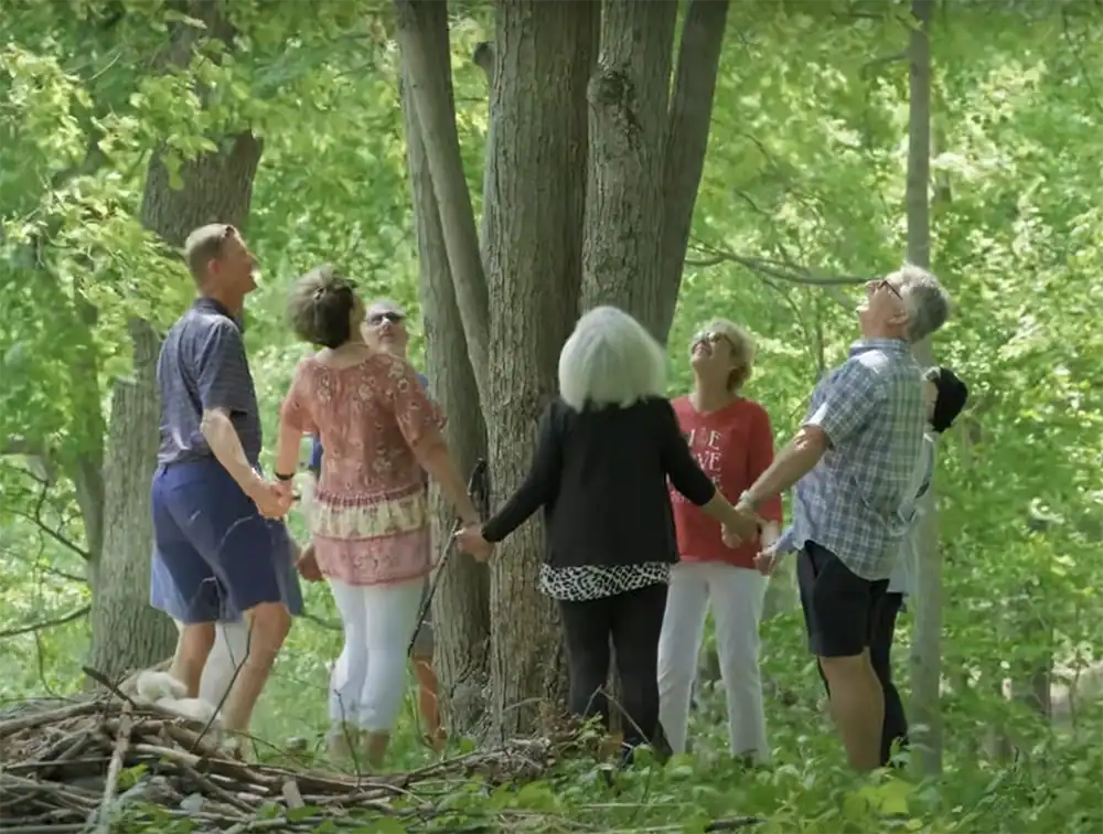 family gathers around the tree they will be coming home to when they all pass