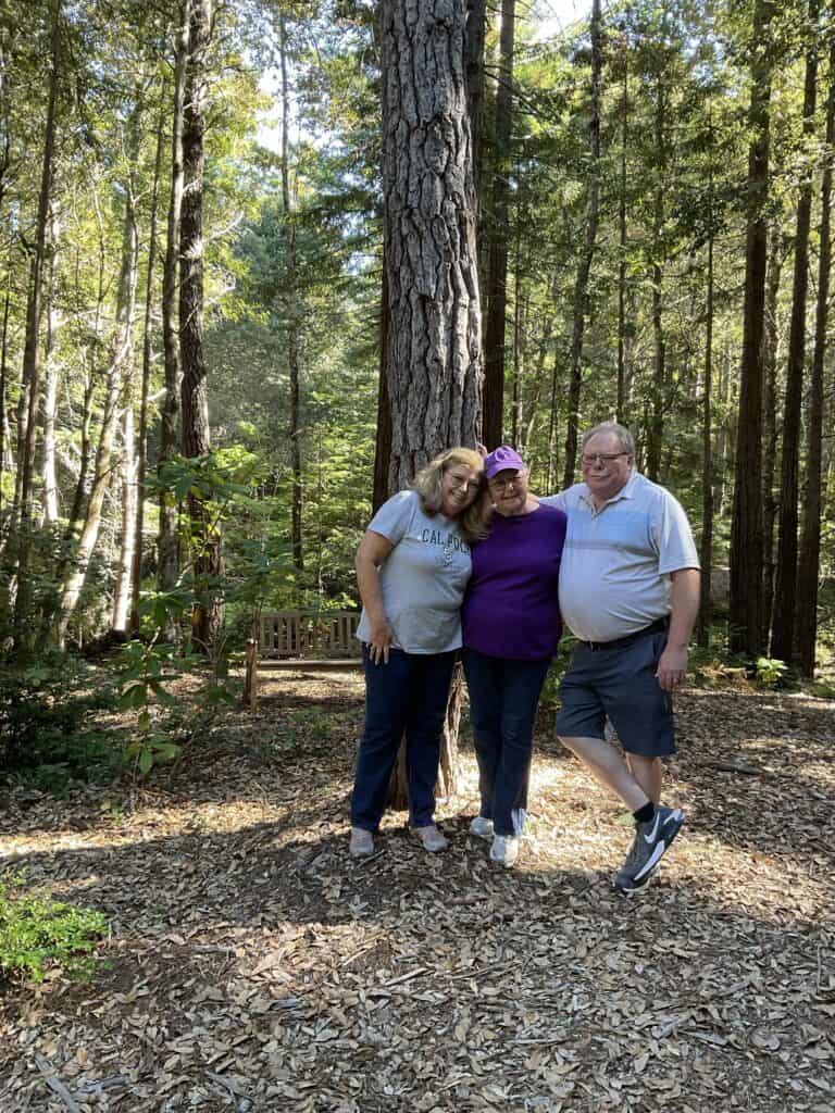 darlla with her husband and friend at her memorial tree happy place