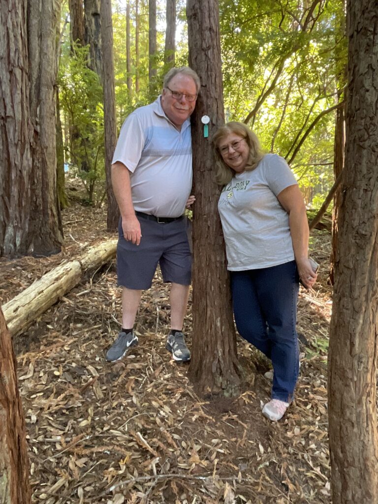 darlla and her husband at her happy place, her memorial tree