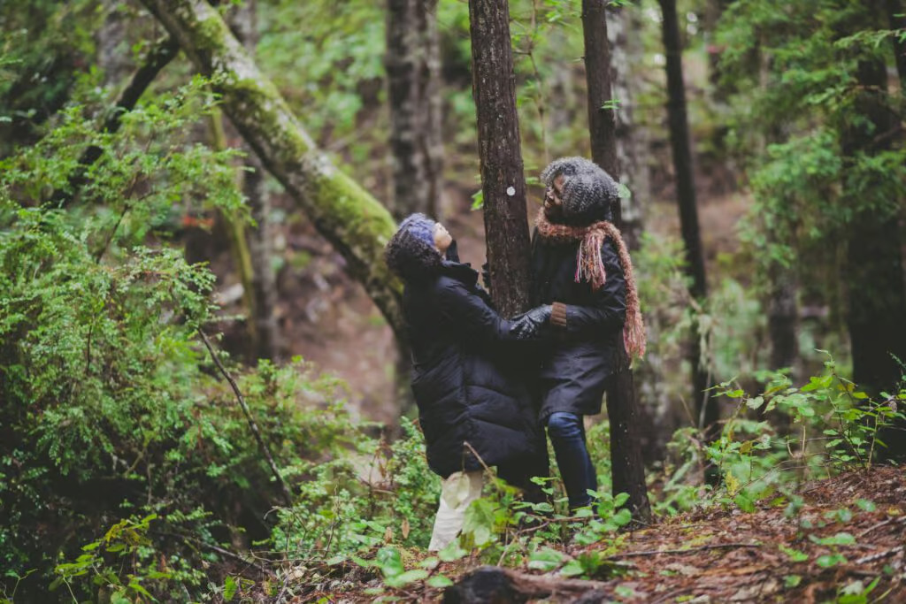 a mom and daughter walk through the memorial forest