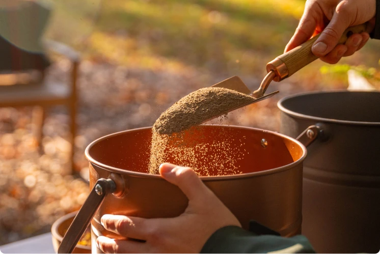 ashes being mixed in a vessel at a forest memorial